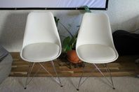 Two white chairs for sale.