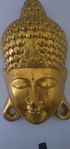 Gyllene Buddha-mask, snidad väggkonst