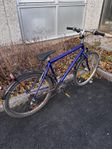 Second-hand bike with front snow tire and new back tire. 