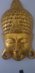 Gyllene Buddha-mask, snidad väggkonst