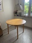 Runt matbord med iläggskiva