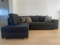 Mörkgrå hörnsoffa med divan och bäddfunktion