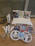 Wii konsol, kontroller, ratt,balansbräda, olika spel.  