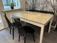Förlängningsbart matbord, svart pinnsoffa och pinnstolar