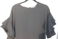 FIORE snygg flare svart topp, stl 38 Helt ny