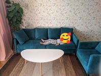 Soffa och fåtölj i blå sammet, soffbord, matta 